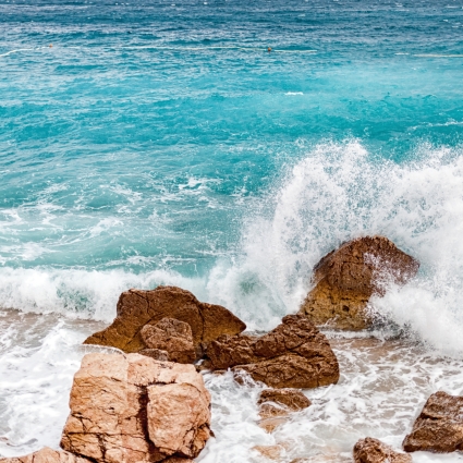 Storm on the tropical sea, crashing waves on rocks